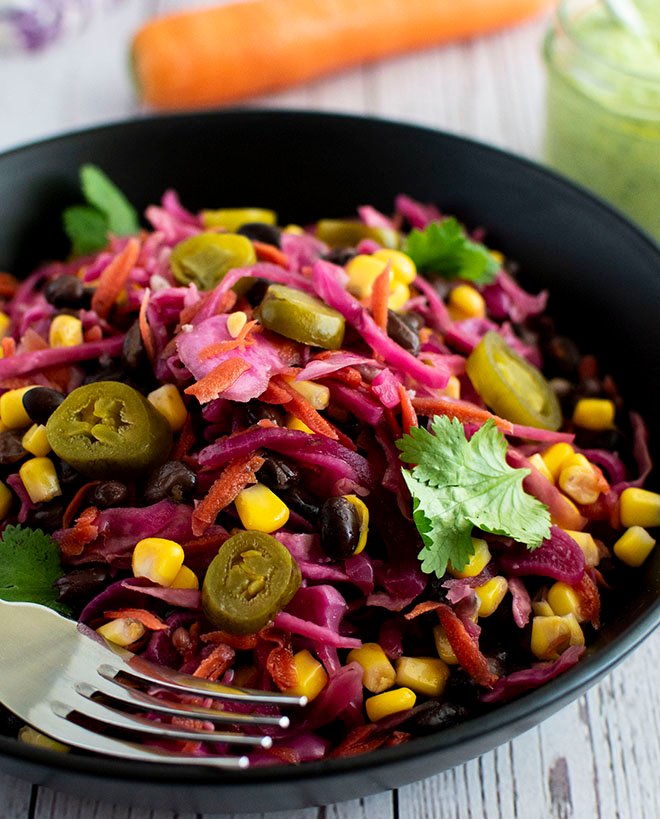 A plate of Mexican pickled cabbage slaw topped with fresh coriander/cilantro and jalapenos.