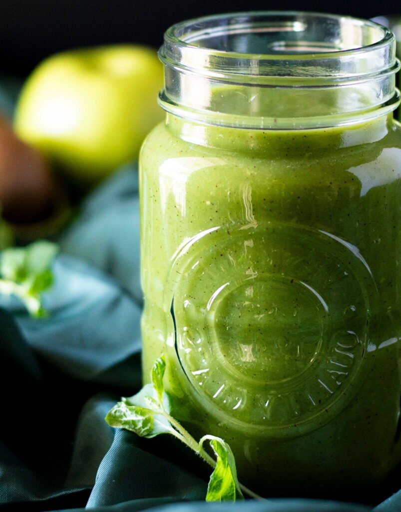 A mason jar filled with fresh kiwi juice.