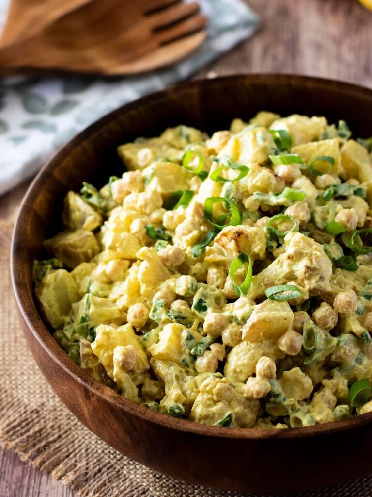 A large bowl of curry cauliflower potato salad.