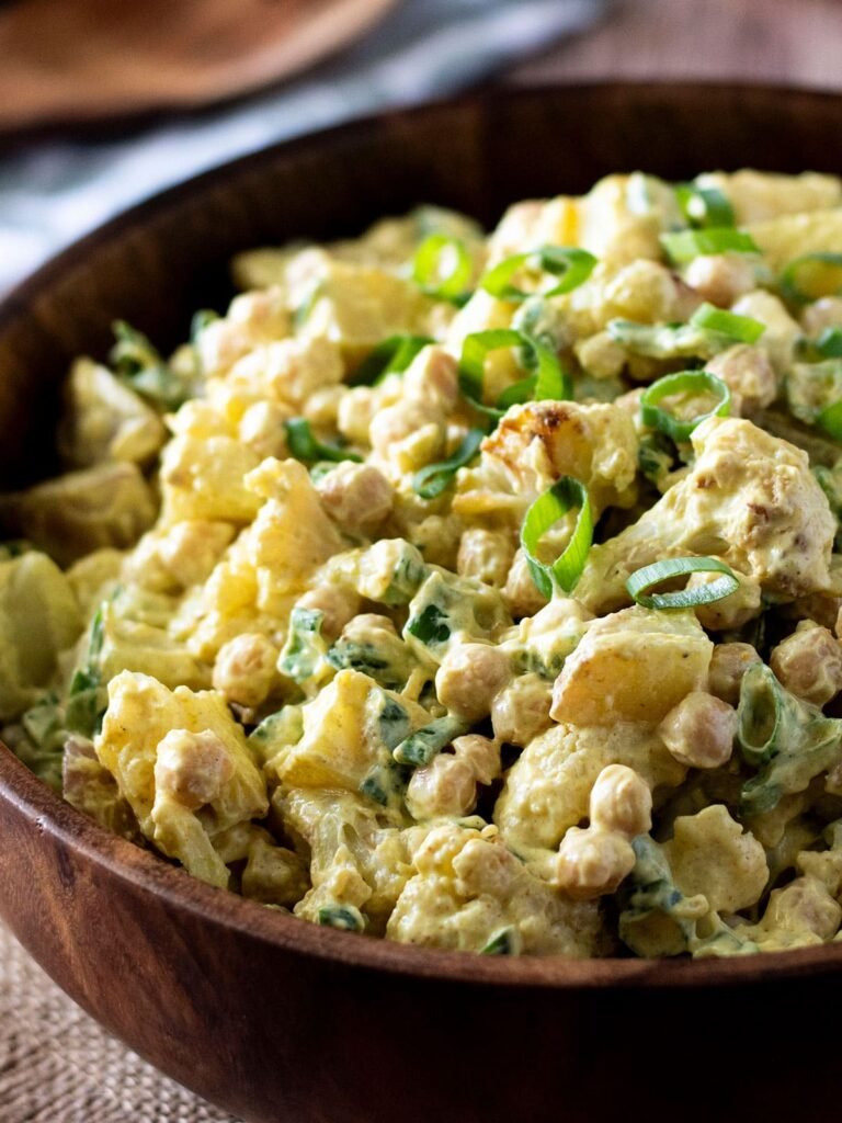 A large bowl of curry cauliflower potato salad.