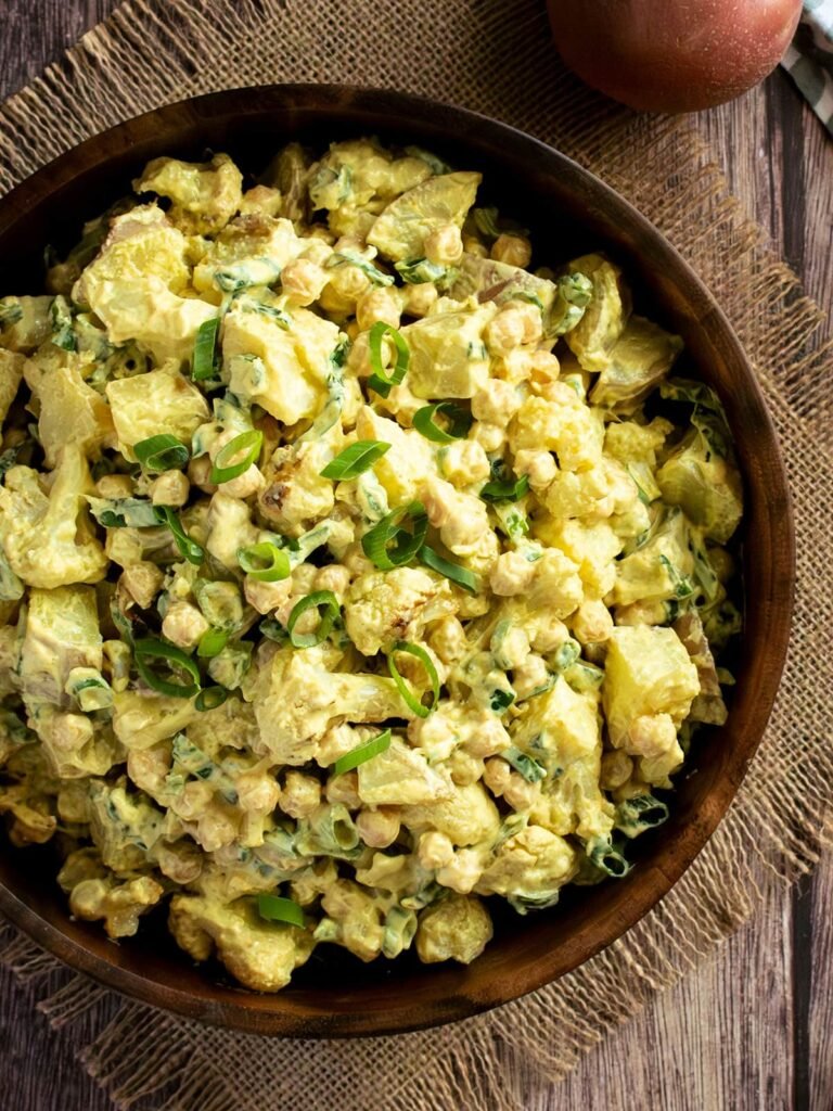 Overhead view of a bowl of curry cauliflower potato salad.