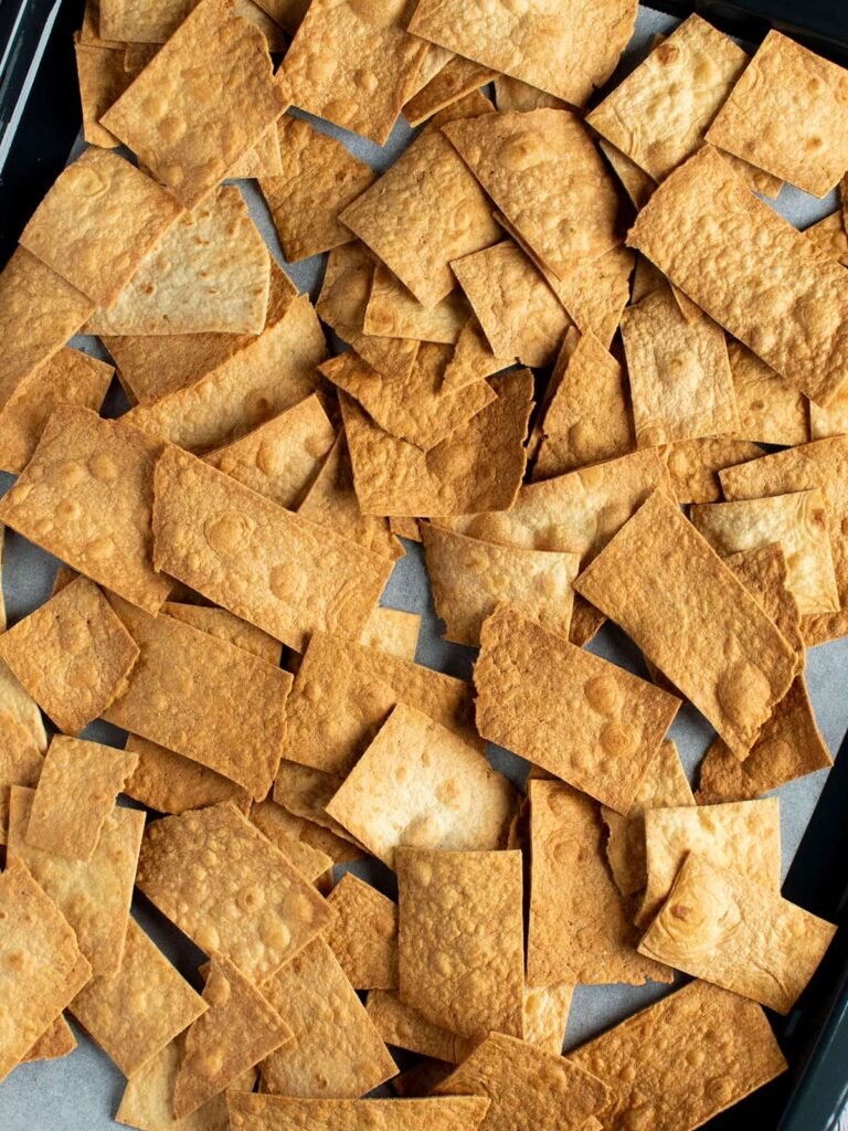 A tray full of baked tortilla chips.