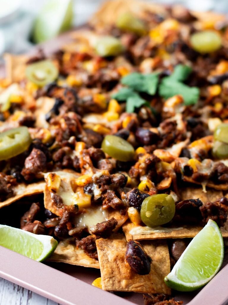 A tray full of beef and bean nachos.