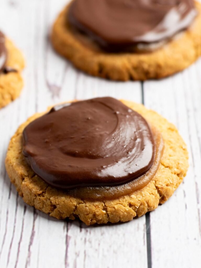 Three Twix Cookies on white wood.