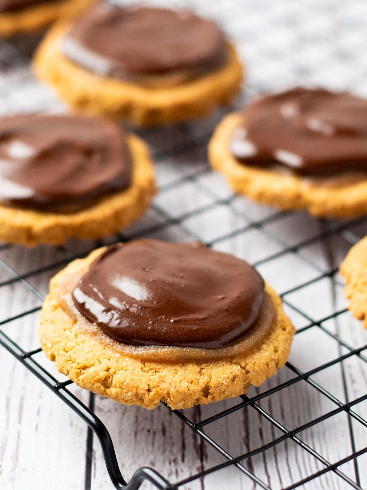 Twix cookies sitting on a cake rack.