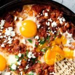 A skillet full of harissa baked beans.