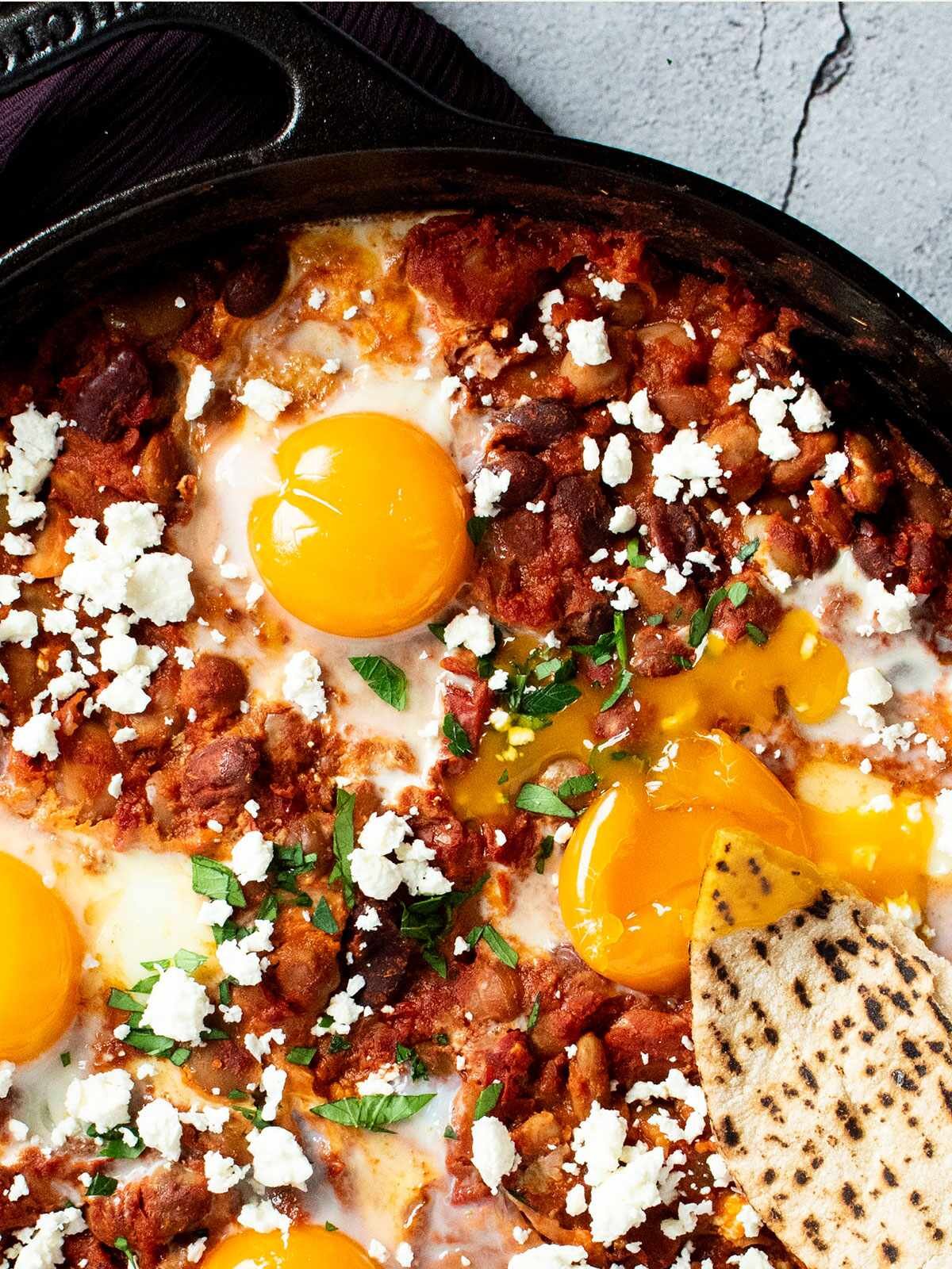 A skillet full of harissa baked beans.