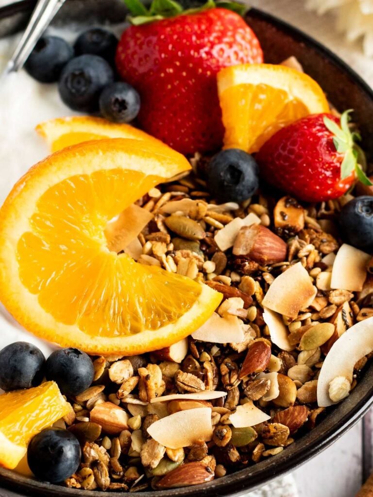 A bowl of tropical granola with fruit.