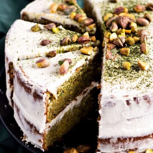 Three slices cut out of a pistachio and matcha cake.