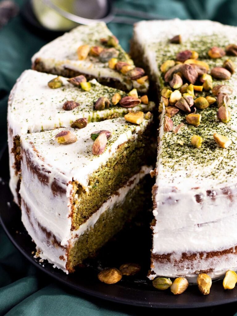 Three slices cut out of a pistachio and matcha cake.