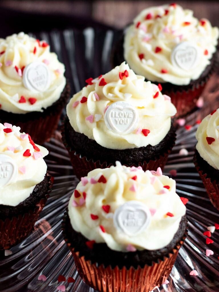 Six chocolate beetroot cupcakes on a cake stand.