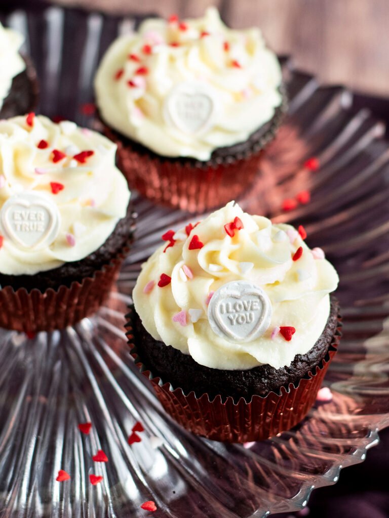 Three chocolate beetroot cupcakes on a cake stand.