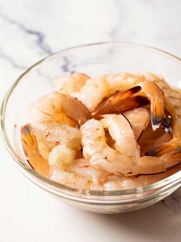 A bowl of raw prawns.