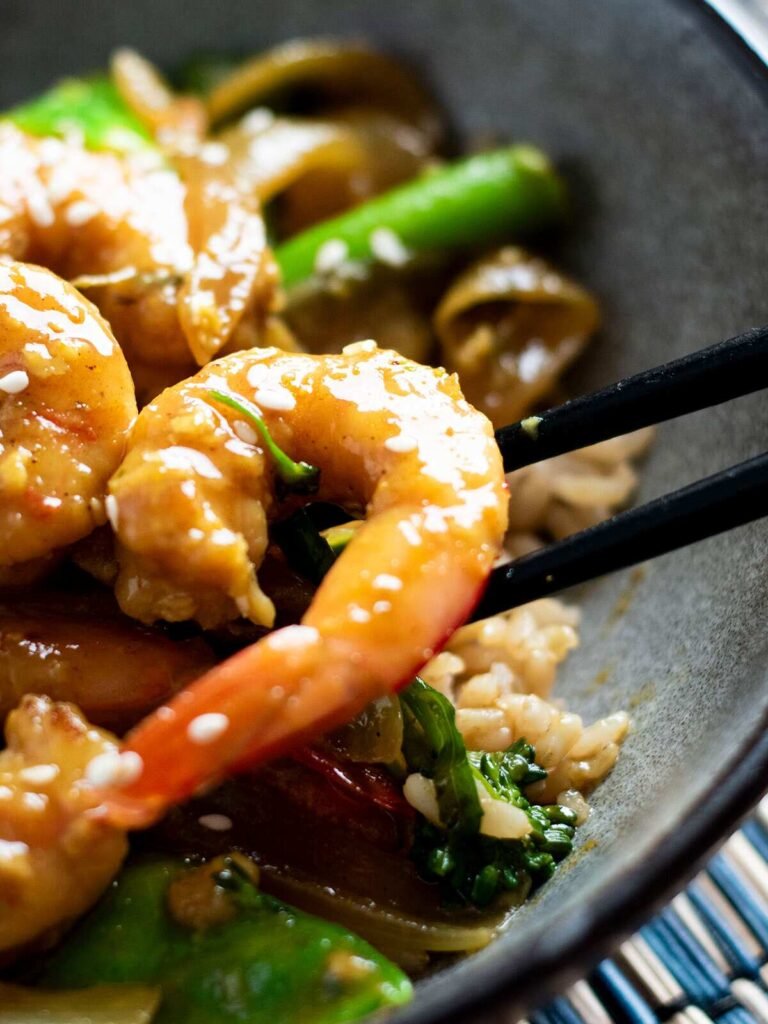 Chopsticks and a bowl of Chinese curry prawns.