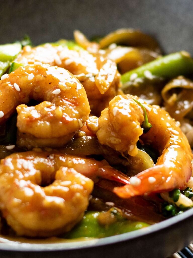 A bowl of curry prawns stir fry.