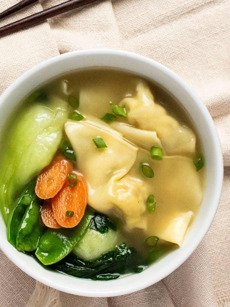 Overhead view of a bowl of Shanghai wonton soup.
