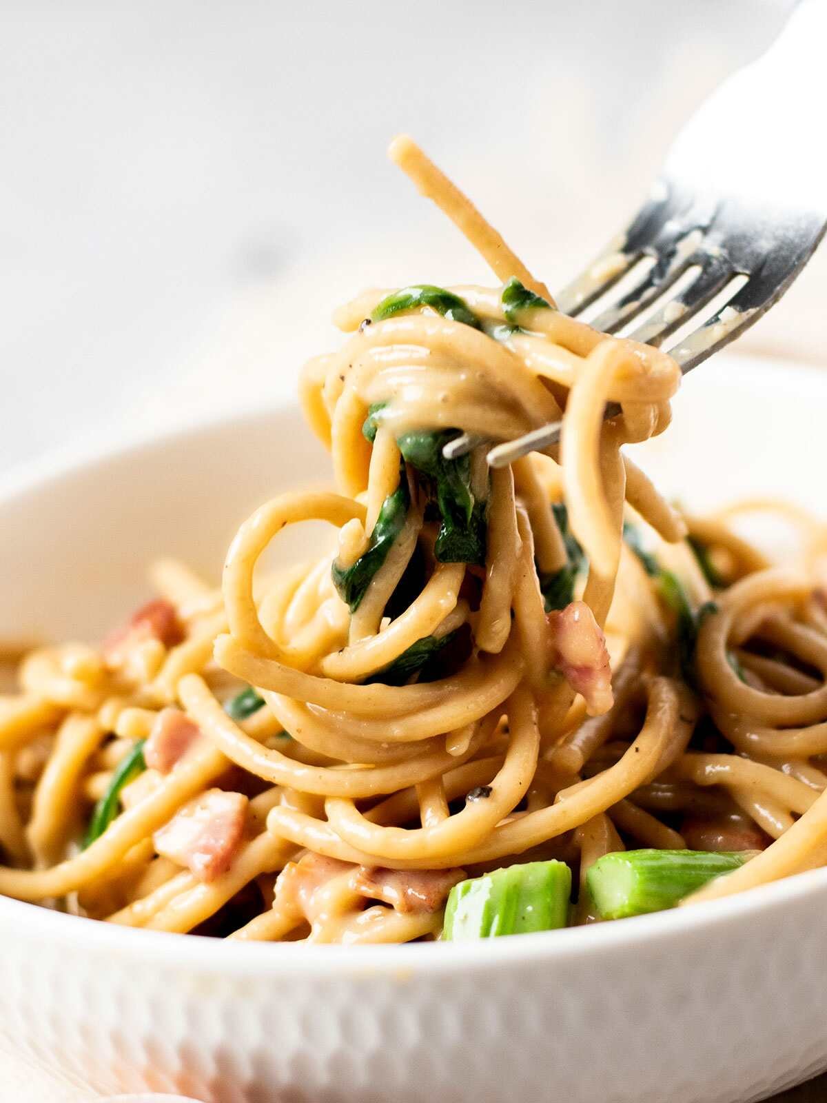 A fork full of healthy vegetable carbonara.